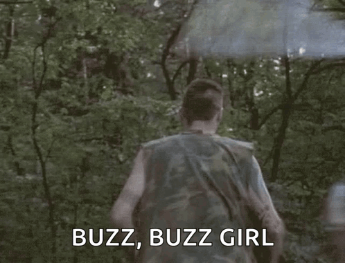 A Man In A Camouflage Shirt Is Running Through A Forest With A Smoke Bomb Coming Out Of His Head . GIF