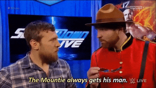 A Man In A Canadian Uniform Is Talking To Another Man In A Plaid Shirt GIF