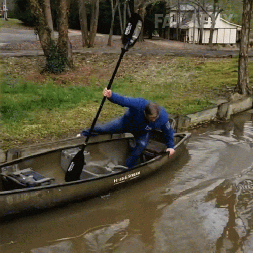A Man In A Canoe With A Paddle That Says Prada Stream On It GIF