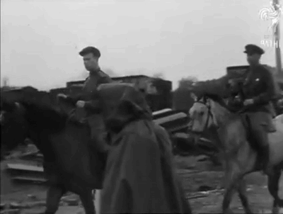 A Man In A Cape Is Riding A White Horse GIF