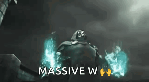 A Man In A Cape Is Standing In Front Of A Building With The Words `` Massive W '' Written Below Him . GIF