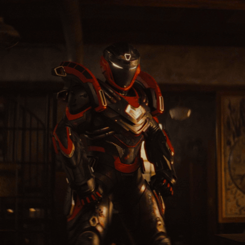 A Man In A Cape Stands In A Dark Room GIF