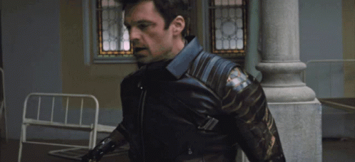 A Man In A Captain America Costume Is Being Held By Another Person GIF