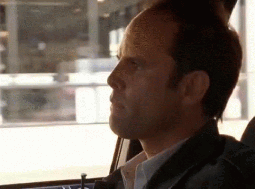 A Man In A Car Looking Out The Window GIF