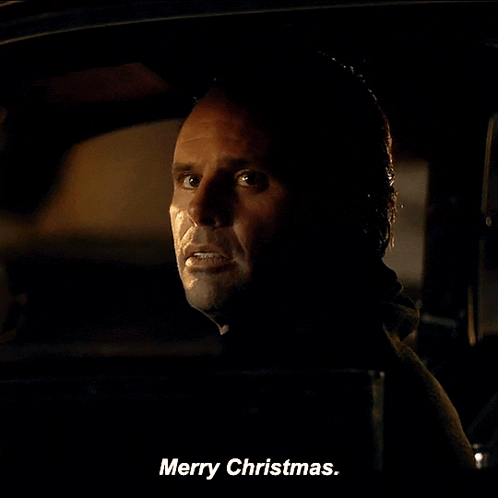 A Man In A Car Says Merry Christmas On The Screen GIF