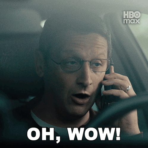 A Man In A Car Talking On A Cell Phone With The Words Oh Wow On The Bottom GIF