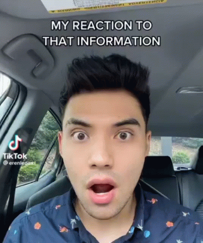 A Man In A Car With A Surprised Look On His Face Says " My Reaction To That Information " On The Bottom GIF