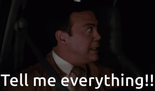 A Man In A Car With The Words Tell Me Everything Written Below Him GIF