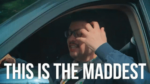 A Man In A Car With The Words This Is The Maddest GIF