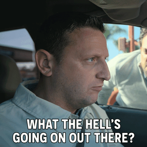 A Man In A Car With The Words What The Hell 'S Going On Out There Written Below Him GIF