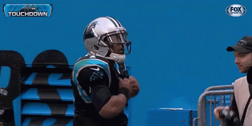 A Man In A Carolina Panthers Jersey Is Being Photographed By A Fox Sports Photographer GIF