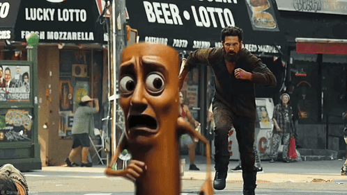 A Man In A Cartoon Costume Is Running Away From A Sausage Man In Front Of A Beer Lotto Store GIF