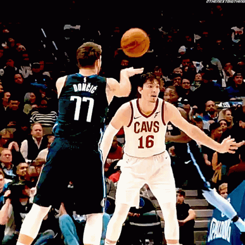A Man In A Cavs Jersey Throws A Basketball At Another Man GIF
