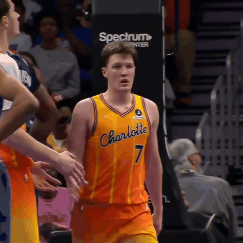 A Man In A Charlotte Jersey Stands In Front Of A Spectrum Sign GIF