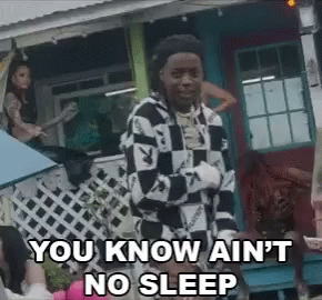 A Man In A Checkered Shirt Is Standing In Front Of A House And Says You Know Ain 'T No Sleep GIF