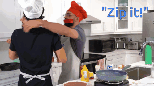 A Man In A Chef Hat Is Hugging Another Man In A Kitchen With The Words " Zip It " Behind Them GIF
