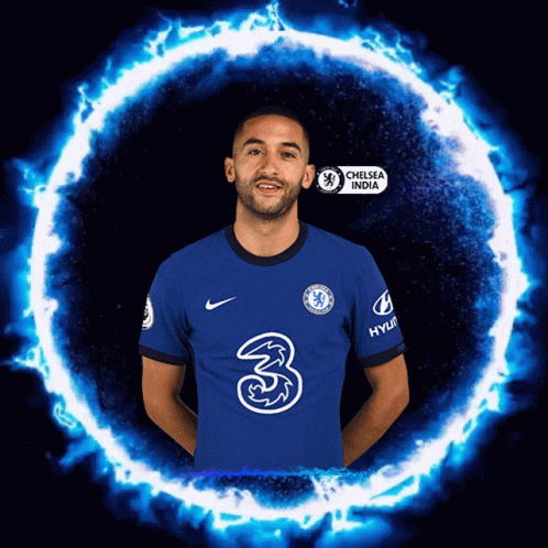 A Man In A Chelsea India Jersey Stands In Front Of A Blue Fire Circle GIF