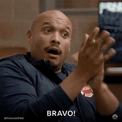 A Man In A Chicago Fire Department Jacket Applauds GIF