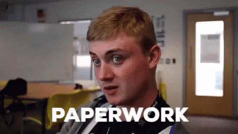 A Man In A Classroom With The Word Paperwork Written Above Him GIF