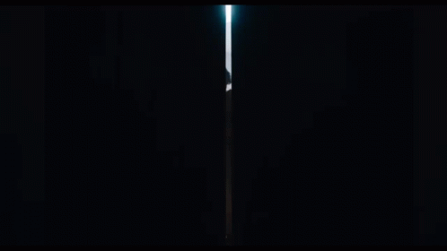 A Man In A Cloak Is Standing In A Dark Tunnel GIF