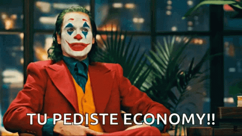 A Man In A Clown Costume Is Sitting In Front Of A Window And Says Tu Pediste Economy GIF