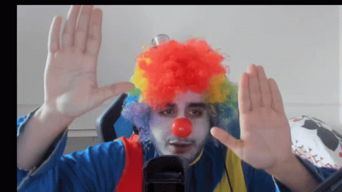 A Man In A Clown Costume With A Red Nose GIF