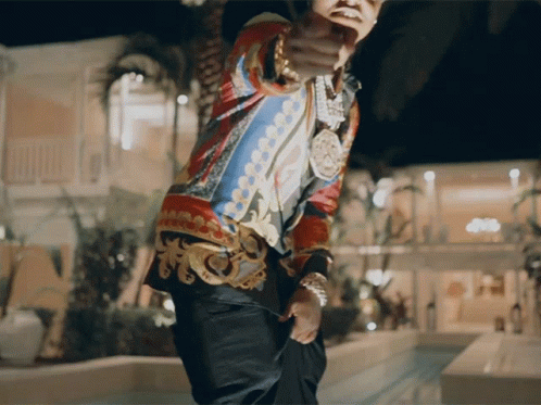 A Man In A Colorful Shirt Is Pointing His Finger At The Camera GIF