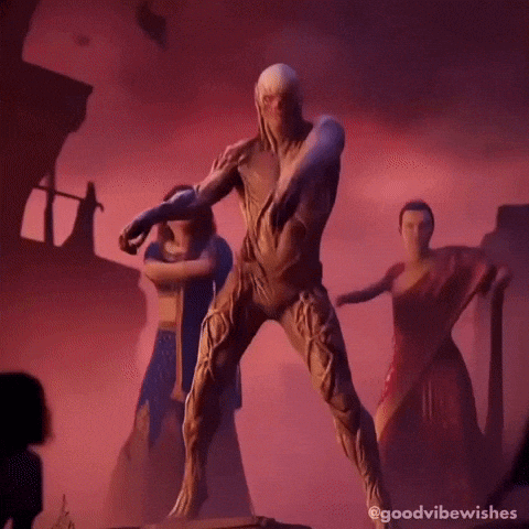 A Man In A Costume Is Dancing With A Group Of Women In Saris . GIF