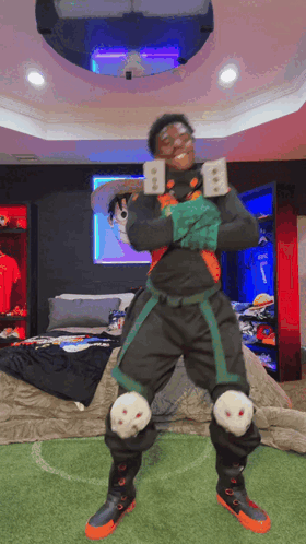 A Man In A Costume Is Standing In A Bedroom Holding A Sword . GIF