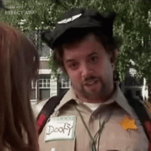 A Man In A Costume Is Talking To A Woman In A Park . GIF