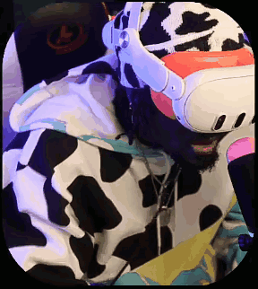 A Man In A Cow Print Hoodie Is Wearing A Virtual Reality Headset . GIF