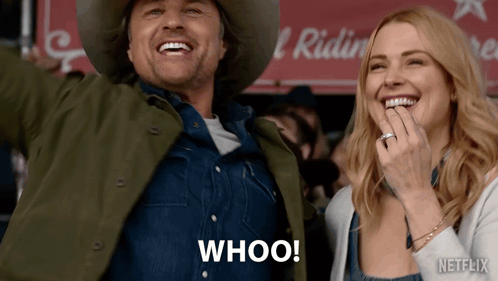 A Man In A Cowboy Hat And A Woman In Overalls Are Laughing And The Man Is Saying Whoo! GIF