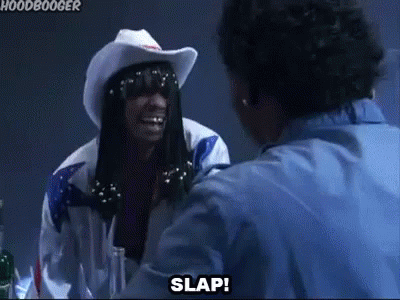 A Man In A Cowboy Hat And Sunglasses Is Talking To Another Man In A Blue Shirt . GIF