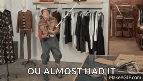 A Man In A Cowboy Hat Is Holding A Fishing Rod In A Clothing Store And Says Ou Almost Had It . GIF