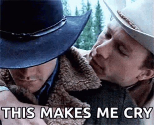 A Man In A Cowboy Hat Is Hugging Another Man In A Jacket . GIF