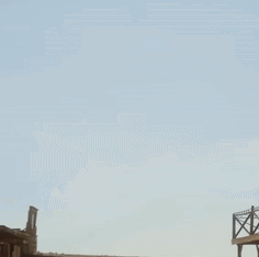 A Man In A Cowboy Hat Is Raising His Fist GIF