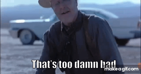 A Man In A Cowboy Hat Is Sitting On The Ground In Front Of A Car . GIF