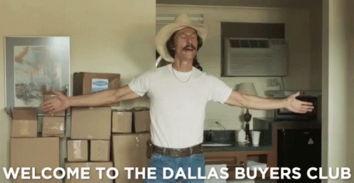 a man in a cowboy hat is standing in front of boxes and the words welcome to the dallas buyers club
