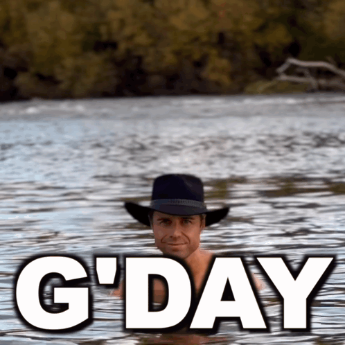a man in a cowboy hat is swimming in a body of water with the words g'day written above him