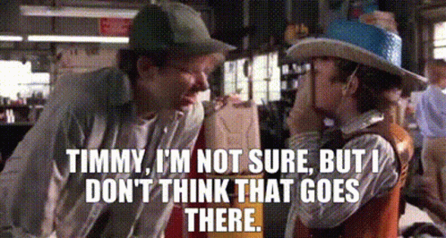 A Man In A Cowboy Hat Is Talking To A Little Boy In A Cowboy Outfit . GIF