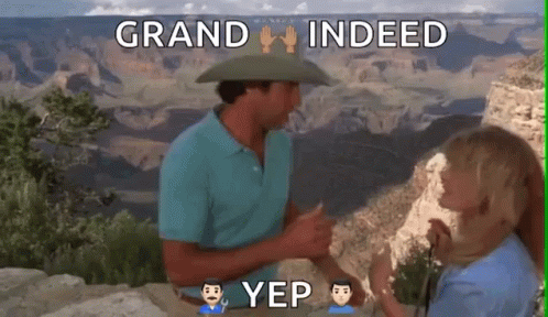 A Man In A Cowboy Hat Is Talking To A Woman In Front Of The Grand Canyon GIF