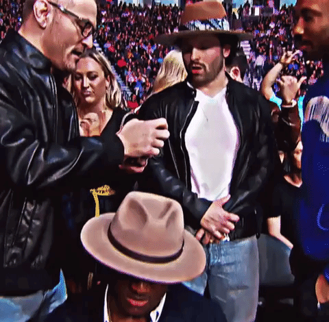 A Man In A Cowboy Hat Is Talking To Another Man GIF