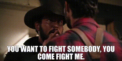 A Man In A Cowboy Hat Is Talking To Another Man In A Plaid Shirt .. GIF