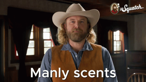 A Man In A Cowboy Hat Says Manly Scents In Front Of A Sign That Says The Squatch GIF