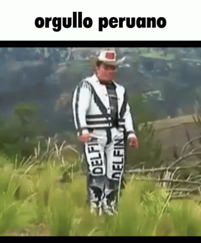 A Man In A Cowboy Outfit Is Standing In A Field With The Words Orgullo Peruano Above Him . GIF