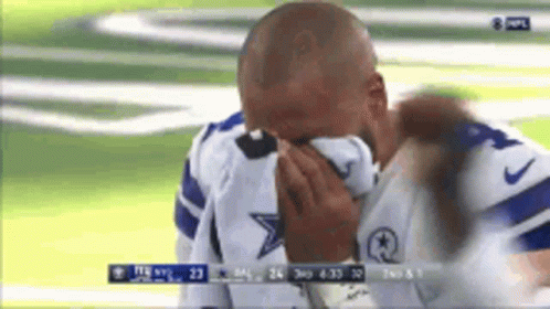 A Man In A Cowboys Jersey Is Crying On A Field GIF