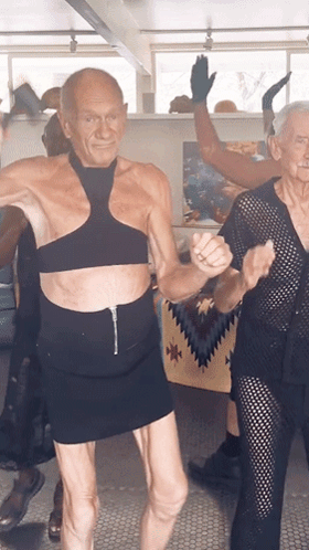 A Man In A Crop Top And A Woman In A Skirt Dancing GIF