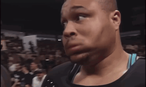 A Man In A Crowd Holds A Sign That Says Undertaker Rules GIF