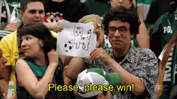 A Man In A Crowd Holds Up A Drawing Of A Cat And Says Please Please Win GIF