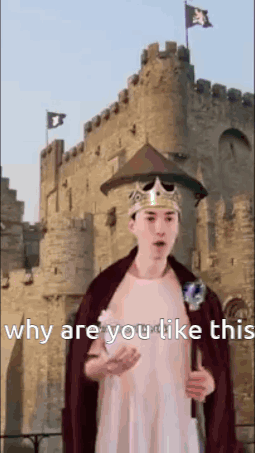 A Man In A Crown And Cape Is Standing In Front Of A Castle Holding A Sword . GIF